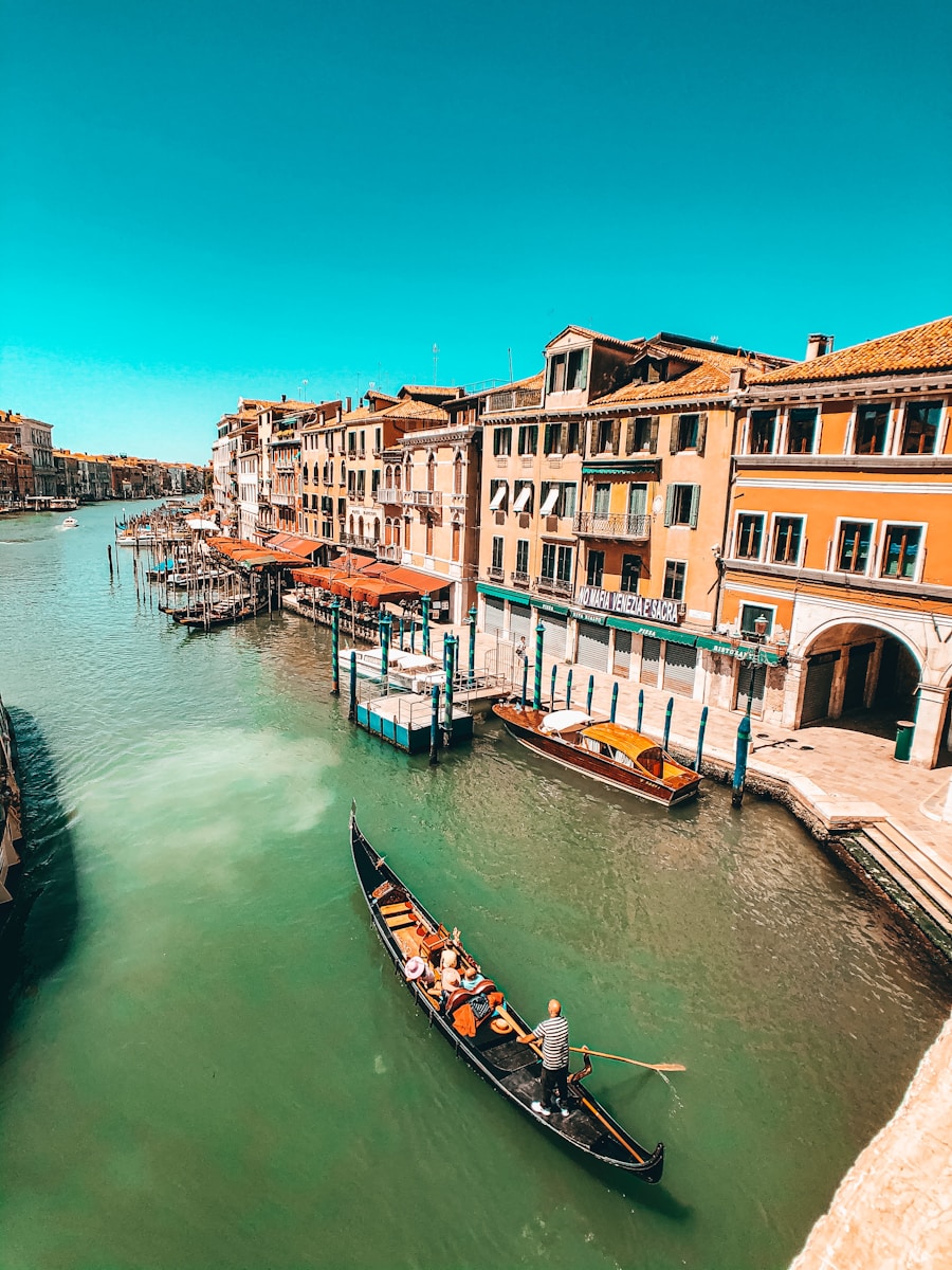 boat on river between buildings during daytime