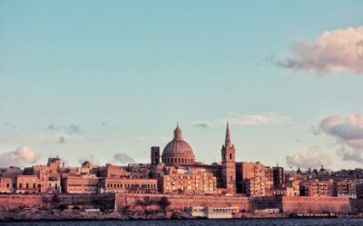 brown concrete dome building near body of water